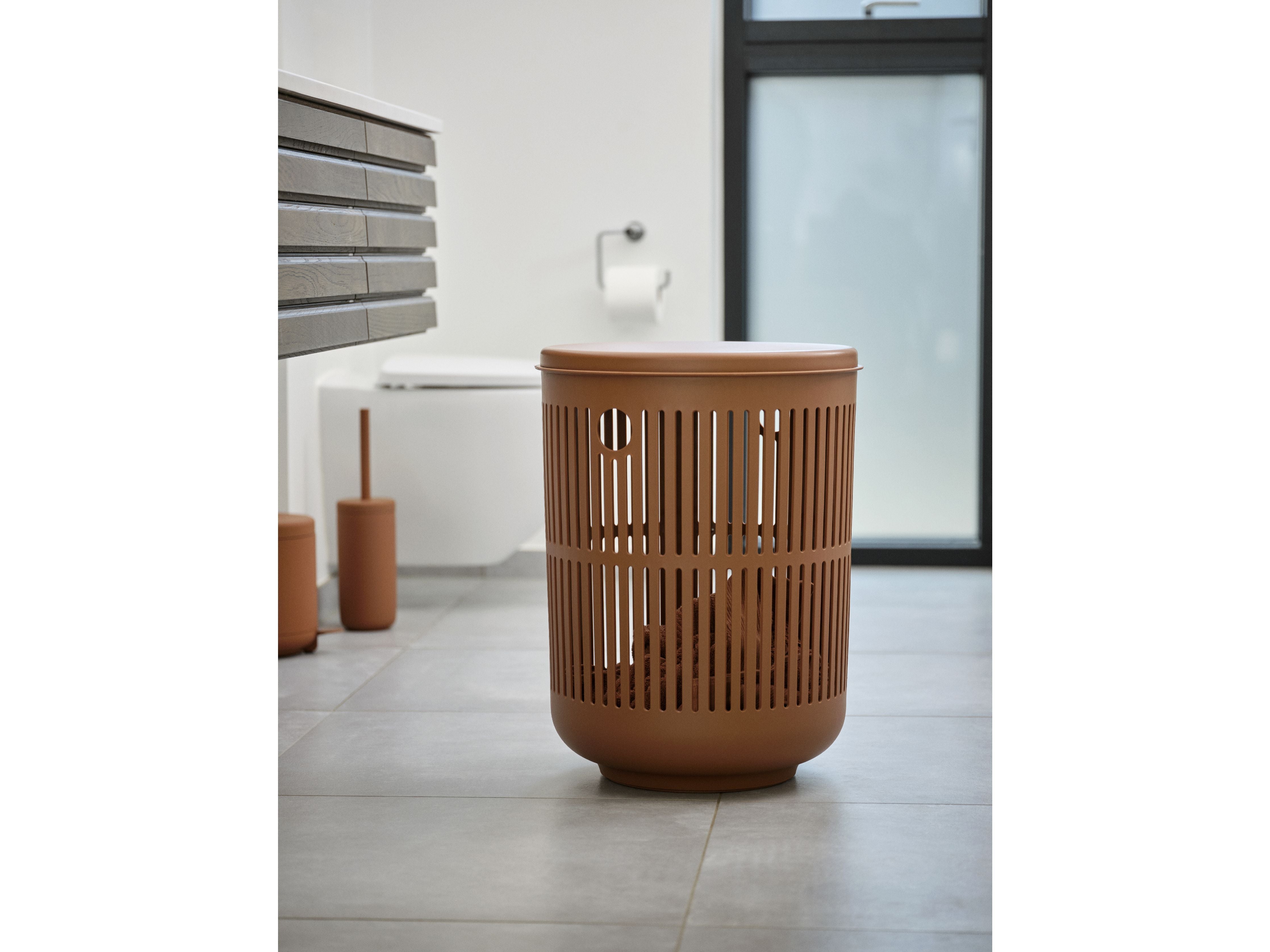 A Zone Denmark Ume Pedal Bin 4 Liter, Terracotta toilet paper holder in a bathroom, part of the Ume bath collection.